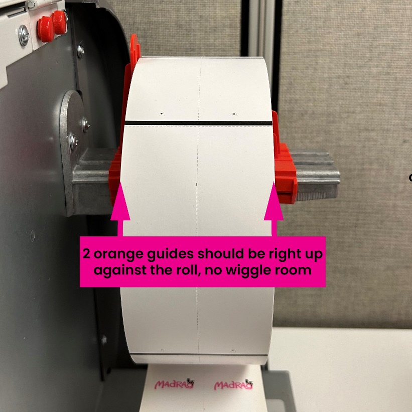 A roll of white paper on a machine

Description automatically generated
