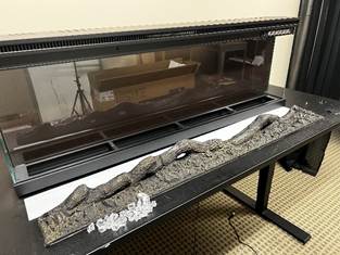 Remving firelog, crystals, and crystal strip from fireplace.