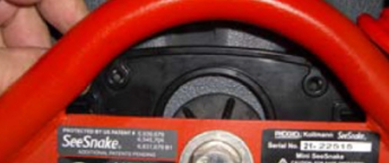 A close-up of a red and black device

AI-generated content may be incorrect.