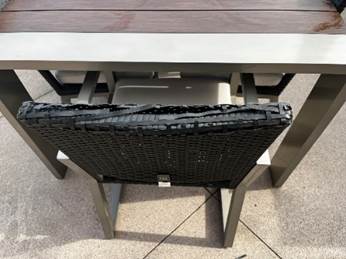 A chair and table on a patio

Description automatically generated