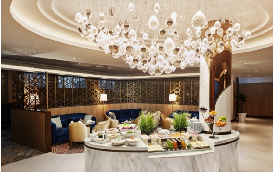 A restaurant with a chandelier

Description automatically generated