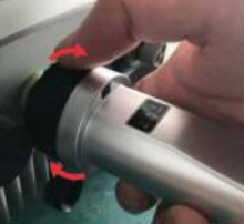 A hand holding a silver object
Description automatically generated