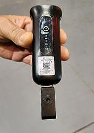 A hand holding a black device 
AI-generated content may be incorrect.