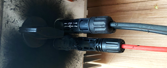 A black plastic connectors on a black surface
Description automatically generated