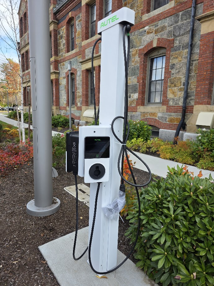 Autel Level 2 EV charging station with charging cable and connector on Lesley University campus