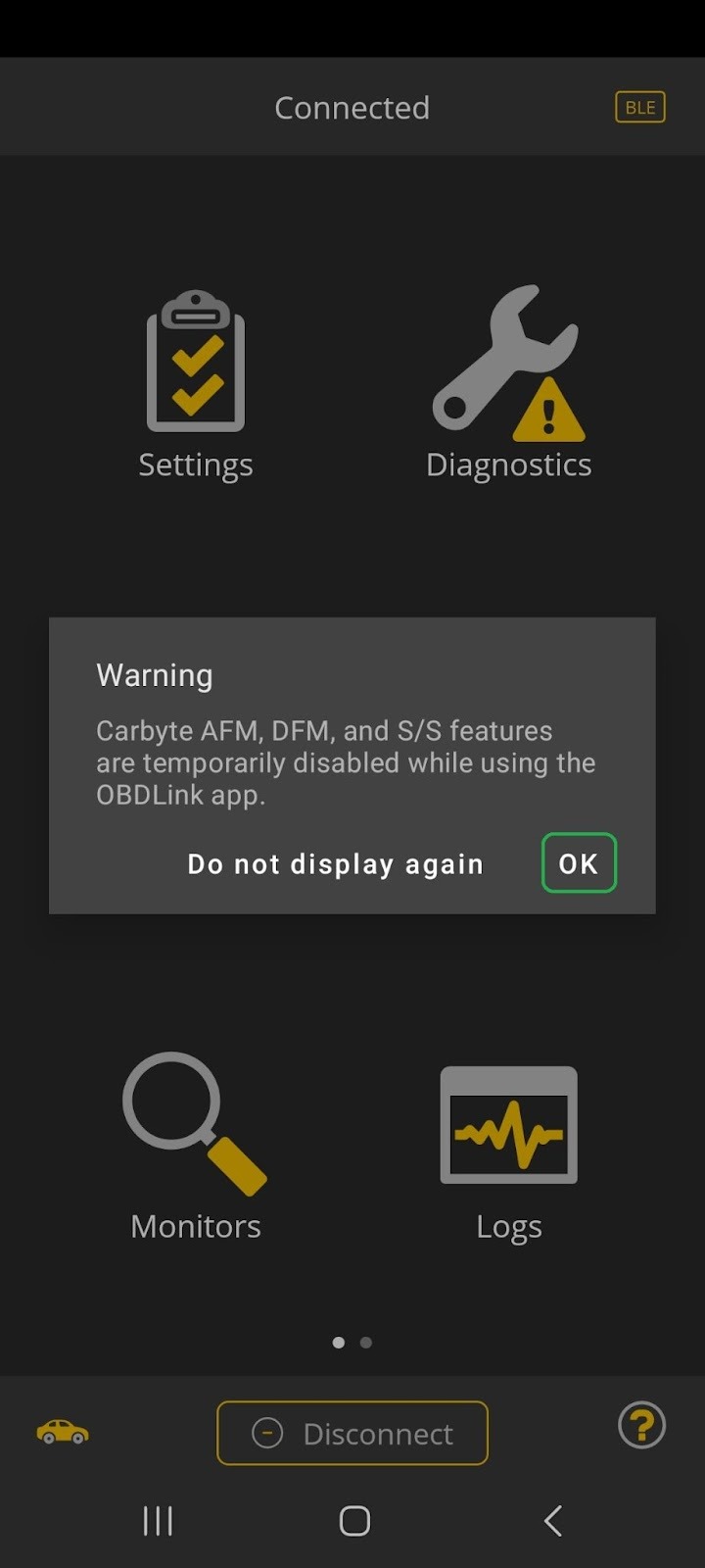 Android screen showing a Warning message in the OBDLink app. The message explains that the Carbyte features can't be used while you are using the OBDLink app. The OK button is highlighted.