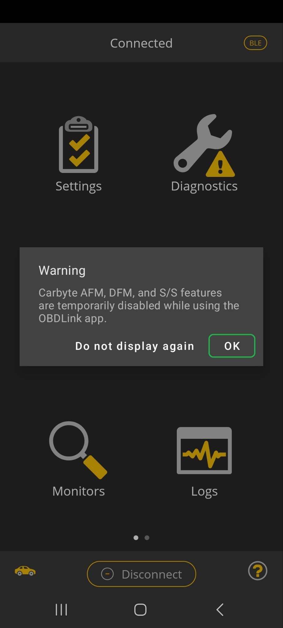Android screen showing a Warning message in the OBDLink app. The message explains that the Carbyte features can't be used while you are using the OBDLink app. The OK button is highlighted.