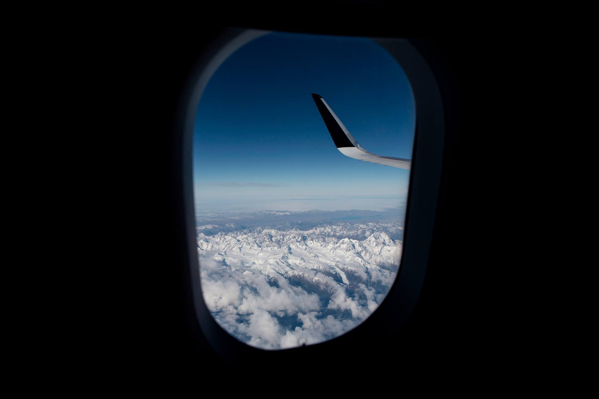 Airplane window view above the clouds