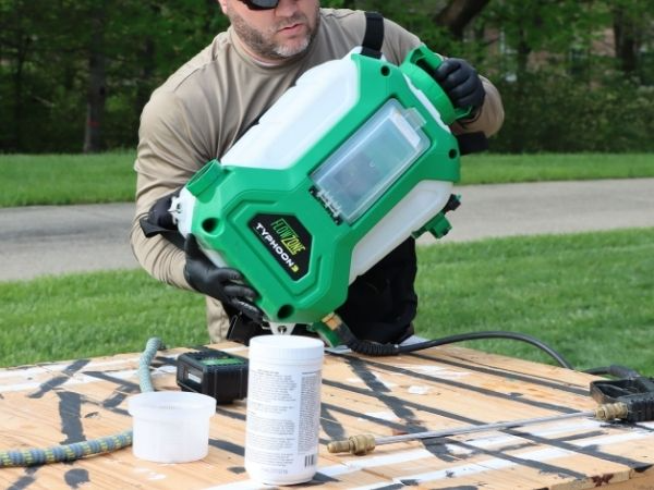man holding a flowzone sprayer