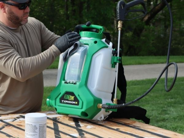man wiping flowzone sprayer using a cloth