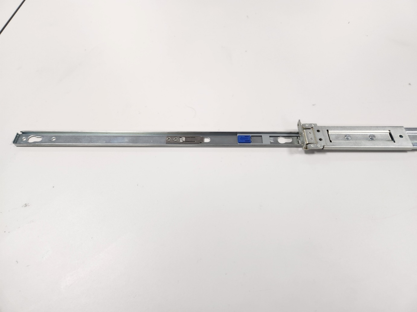 A metal rod with a blue and black screw

Description automatically generated