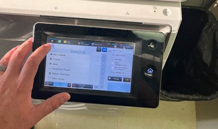 A hand holding a touch screen

Description automatically generated