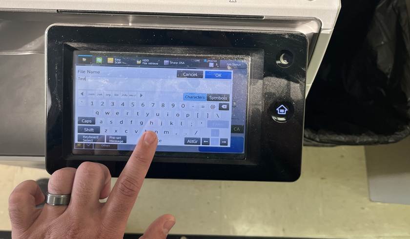 A finger pointing at a screen

Description automatically generated