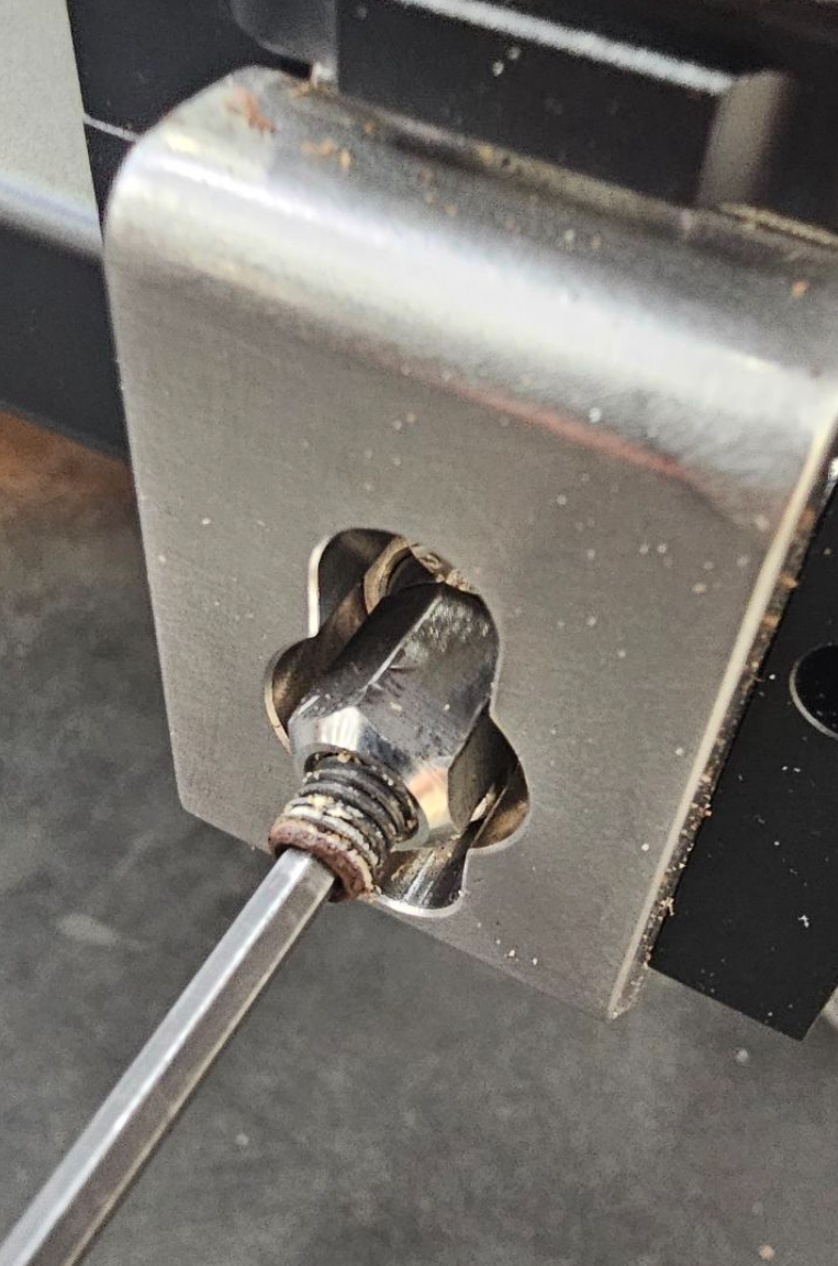 Loosening set screw on pull rod lock nut