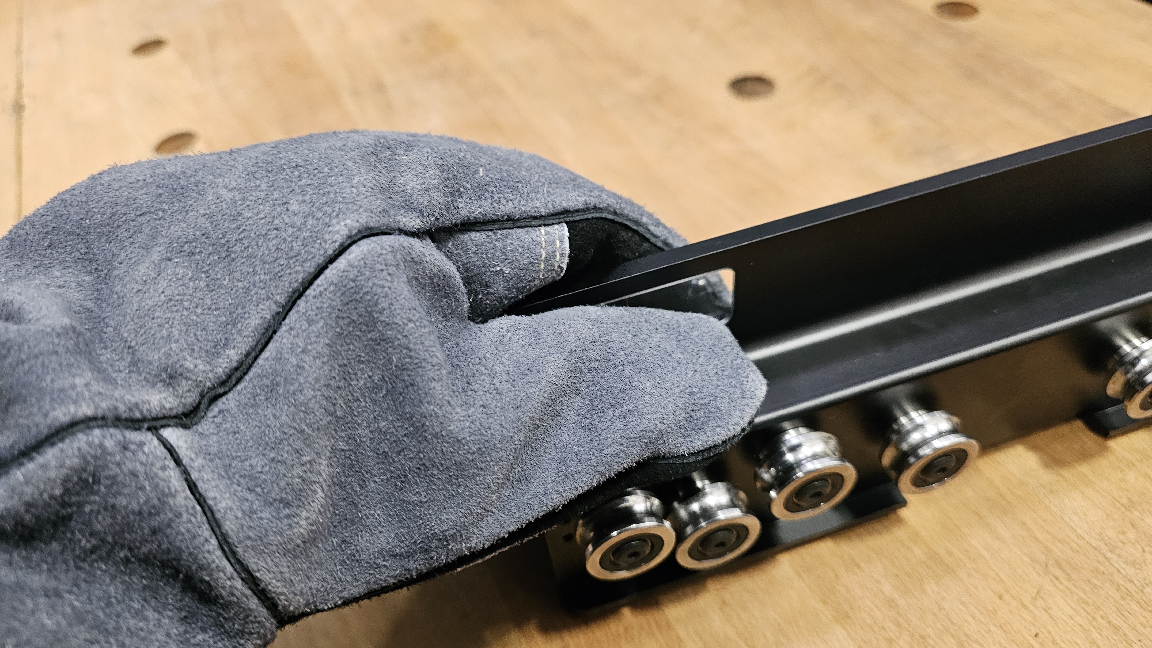 Step 2 — leather glove gripping hot fence rail to remove viewer