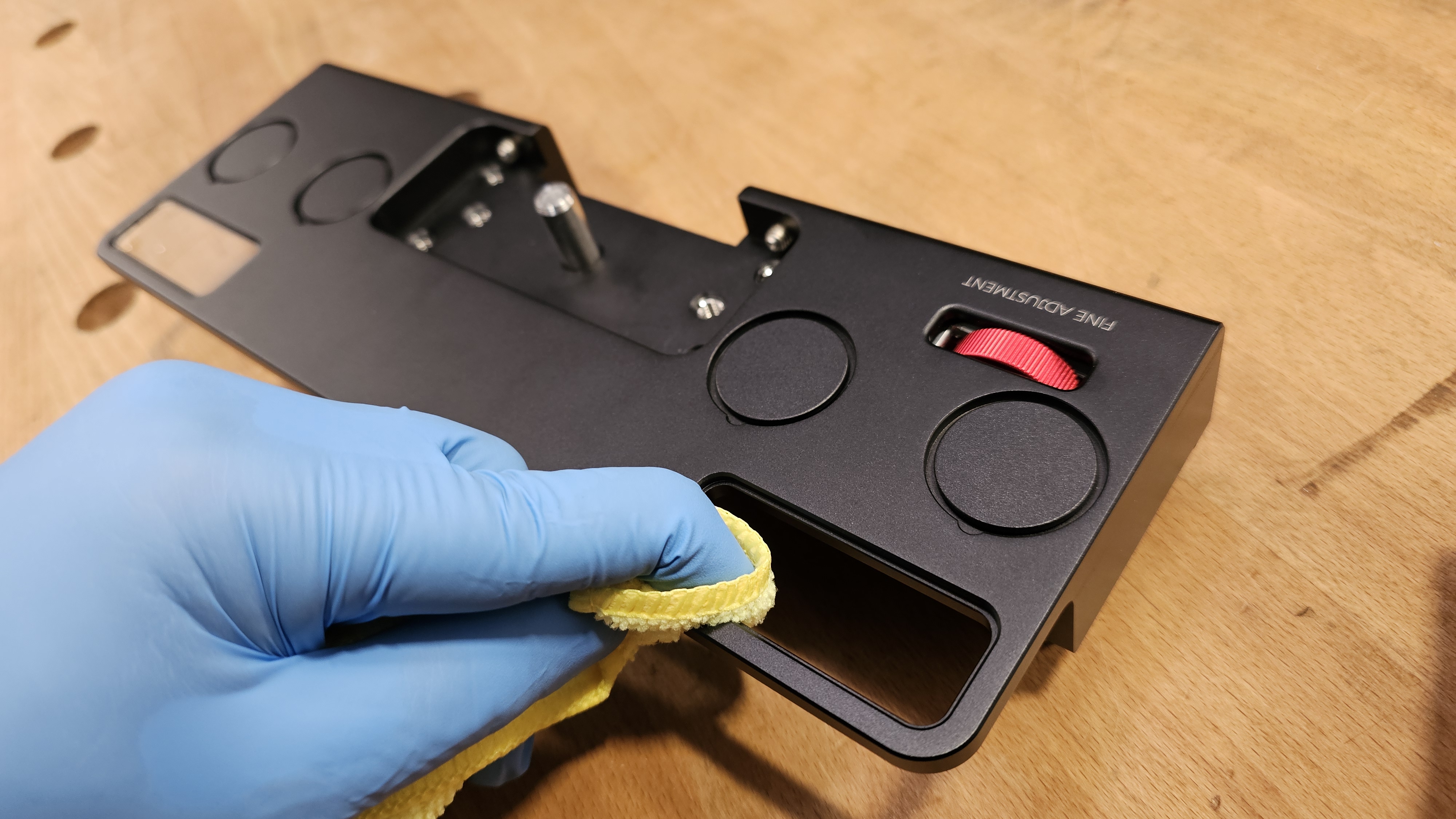 Step 3 — nitrile gloved hand cleaning empty viewer socket with microfiber cloth