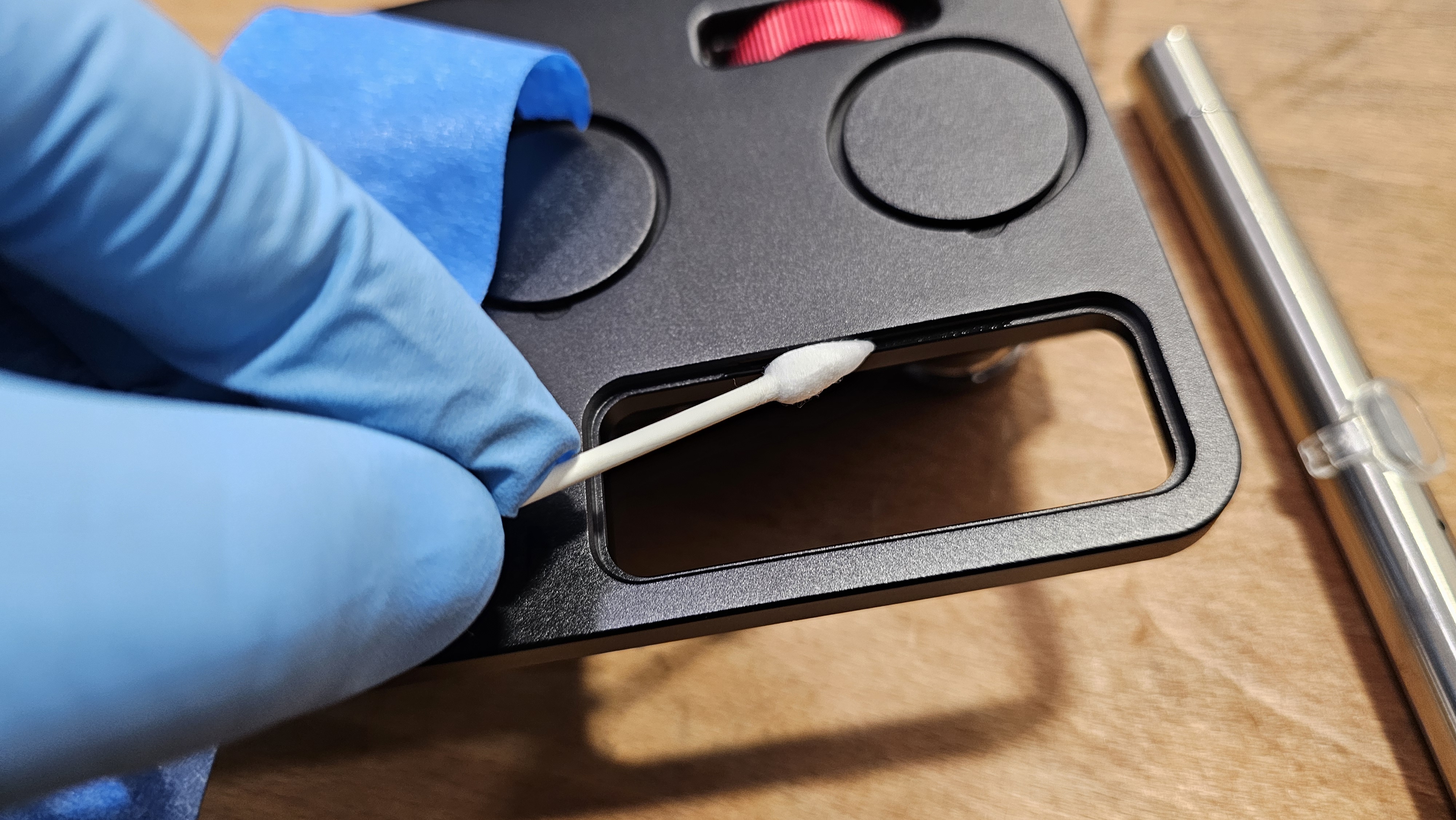Step 7 — Q-tip applying UV resin to inner edge of empty viewer socket