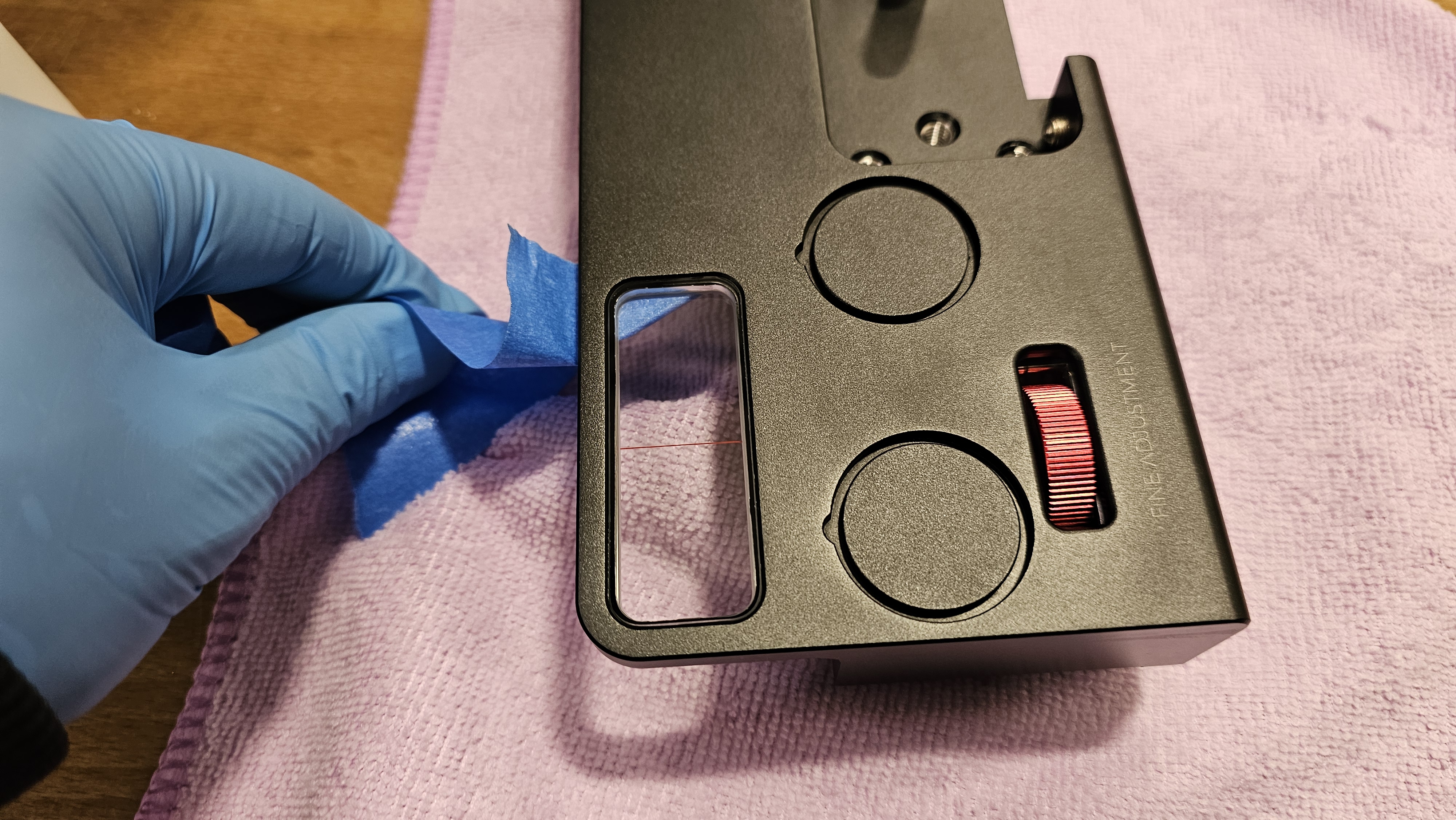 Final — blue tape being removed from viewer socket to reveal finished, clean viewer installation