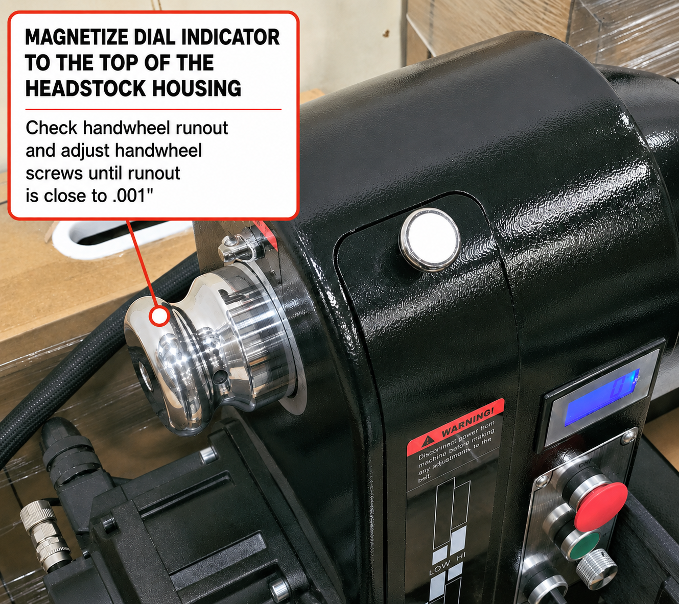 Dial indicator mounted to headstock measuring handwheel runout