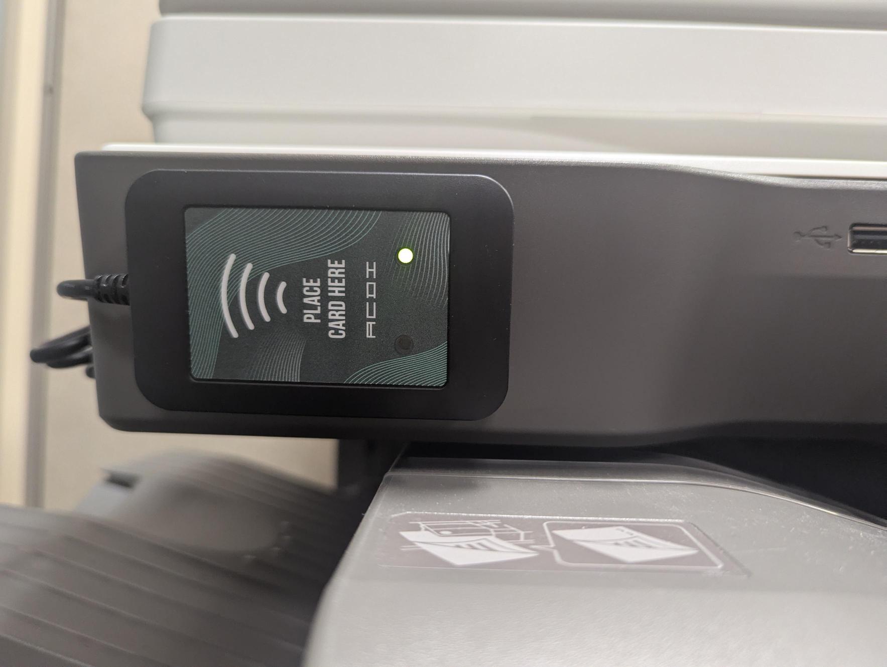 The ID card reader is located to the left of the touchscreen. A green light indicates the reader is ready. The light will flash red and beep while reading a card.