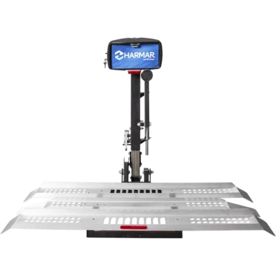 A silver vehicle lift with a black control box labeled "Harmar." It features a metal platform with perforated sections for secure placement.