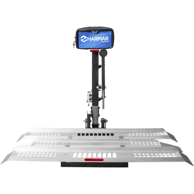 A silver vehicle lift with a black control box labeled "Harmar." It features a metal platform with perforated sections for secure placement.