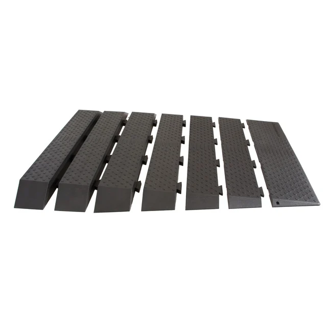 Six black modular cable protector ramps with interlocking edges, featuring a textured surface, designed to safeguard cables and prevent tripping hazards.