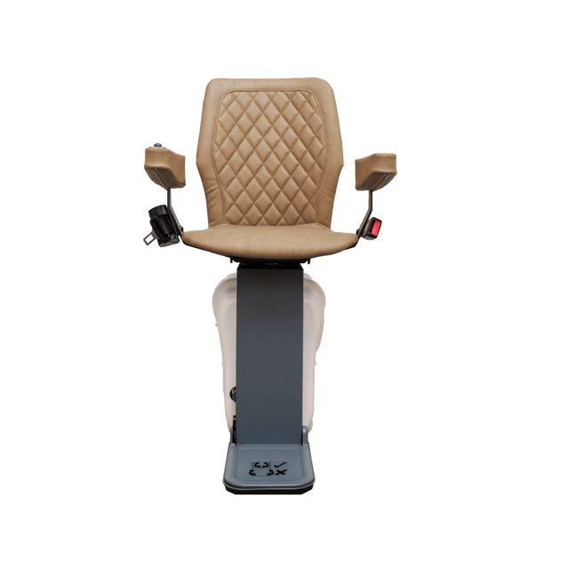 A chairlift with a beige padded seat and armrests, mounted on a vertical rail.