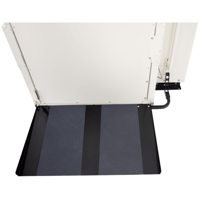 Close-up of a wheelchair ramp with a non-slip surface, leading to a platform or doorway.