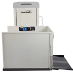 Vertical platform lift with a safety gate, control buttons, and a ramp, used for accessibility and mobility support.