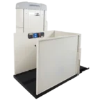 Vertical platform lift with safety gate, control panel, and handlebar, used for accessibility.