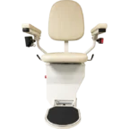 A beige stairlift chair with armrests and a footrest, facing forward.