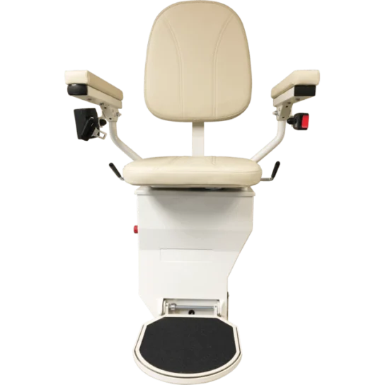 A beige stairlift chair with armrests and a footrest, facing forward.