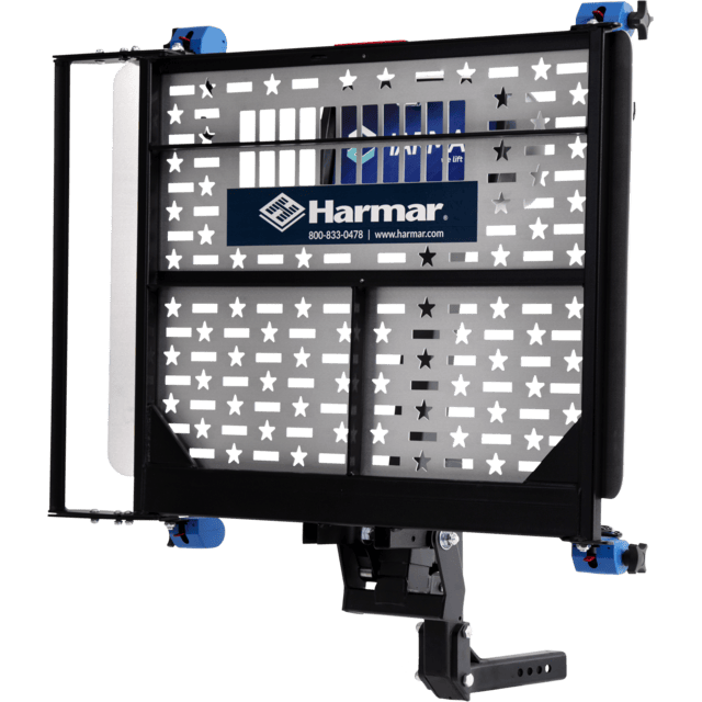 A metal lift platform with star-shaped cutouts and a Harmar logo, designed for mobility device transportation.