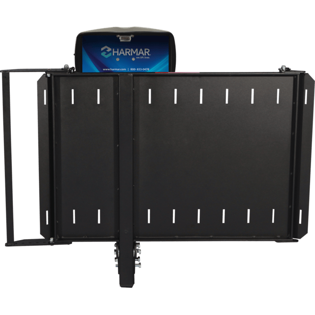 A black Harmar lift with a blue and white label, featuring a platform and railings for mobility devices.