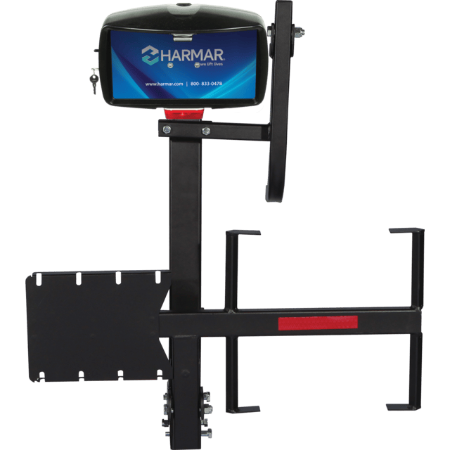 Vehicle lift with Harmar logo, designed for mobility aids. Black metal structure with mounting brackets.