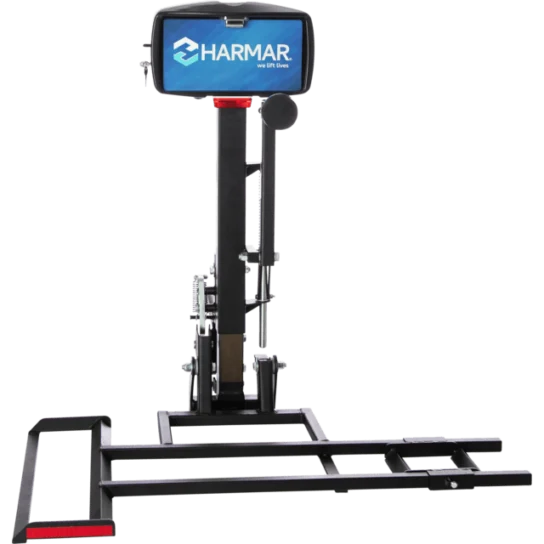 Vertical lift with a blue Harmar sign, featuring a platform and support structure for transporting mobility devices.