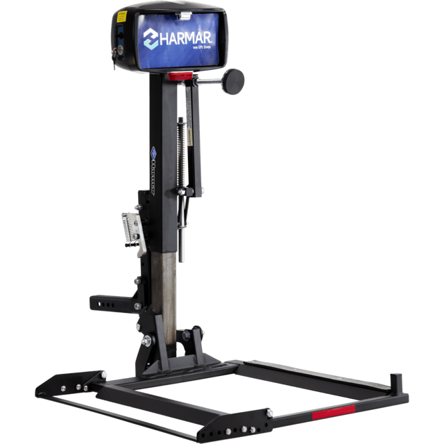 A black Harmar vehicle lift with a platform and various controls, designed for transporting mobility devices like scooters or wheelchairs.