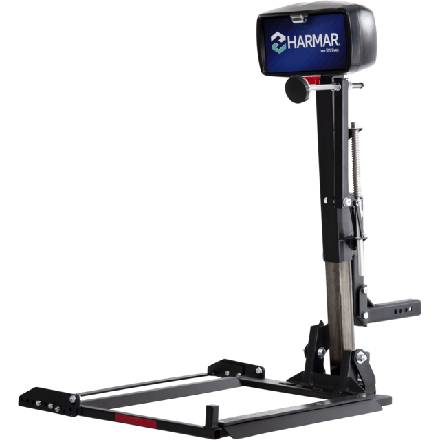 A Harmar vehicle lift for mobility devices, featuring a black metal frame and platform with a vertical post and branded cover at the top.