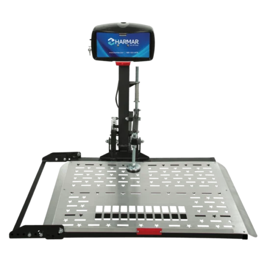 A platform lift with a monitor displaying the Harmar logo, designed for transporting mobility devices, featuring a durable metal platform and a securing mechanism.