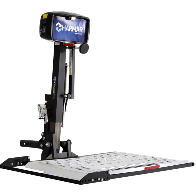 Electric platform lift for wheelchairs with a metal base and vertical support, featuring a Harmar logo on the motor housing.