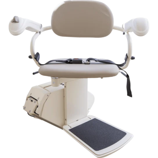 A beige stair lift chair with armrests, seatbelt, and footrest on a motorized base.
