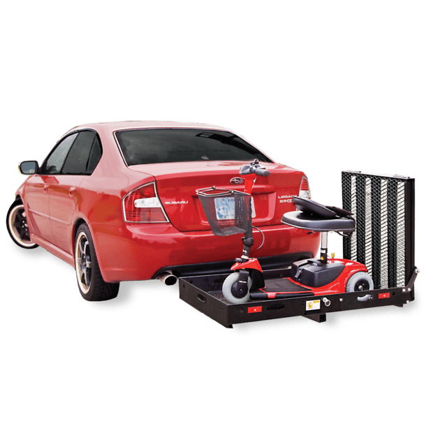 A red car with a mobility scooter attached to the rear on a metal carrier.