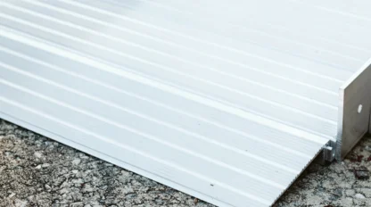 Aluminum ramp placed on concrete ground, featuring horizontal ridges and a slight incline.