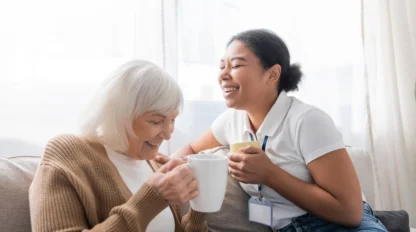 Caregiver with senior woman laughing