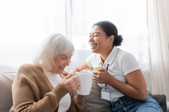 Caregiver with senior woman laughing
