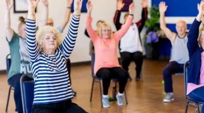 Senior citizens participating in chair exercises