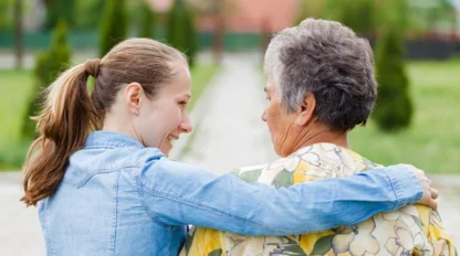caregiver sitting with elderly woman