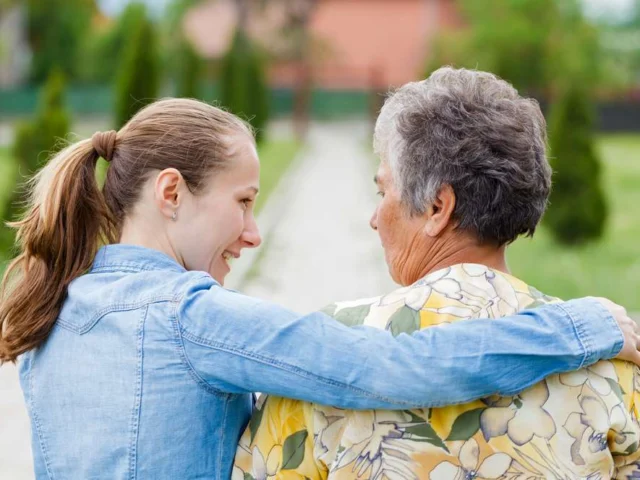 caregiver sitting with elderly woman