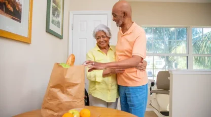 husband hugging wife with stairlift behind them